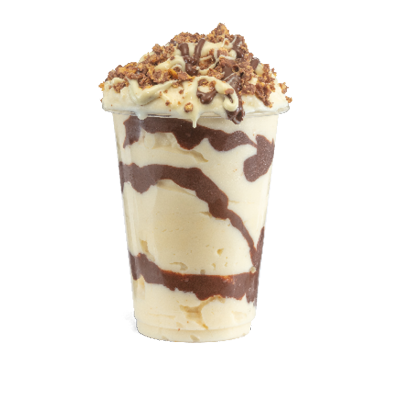 Creamy soft serve ice cream sundae swirled with white and milk chocolate sauce topped with Cadbury crunchie crumb